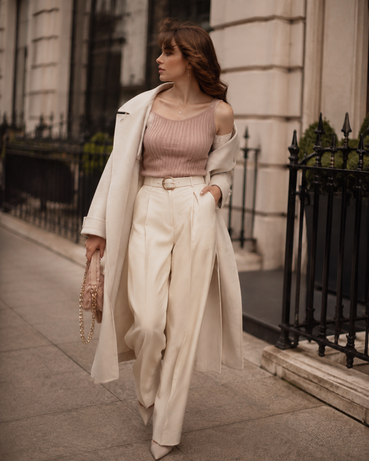Young woman in London street-style outfit, grey-rose and cream palette, moody editorial